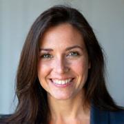 Professional headshot of Elara Vance, a Contrast Dwellings real estate agent, smiling confidently.