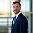 Headshot of David L, a satisfied commercial real estate investor in Portland, standing near a modern building.