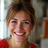 Elara Vance, an artist, smiling creatively.