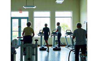 Seniors enjoying a modern fitness center with cardio and strength equipment